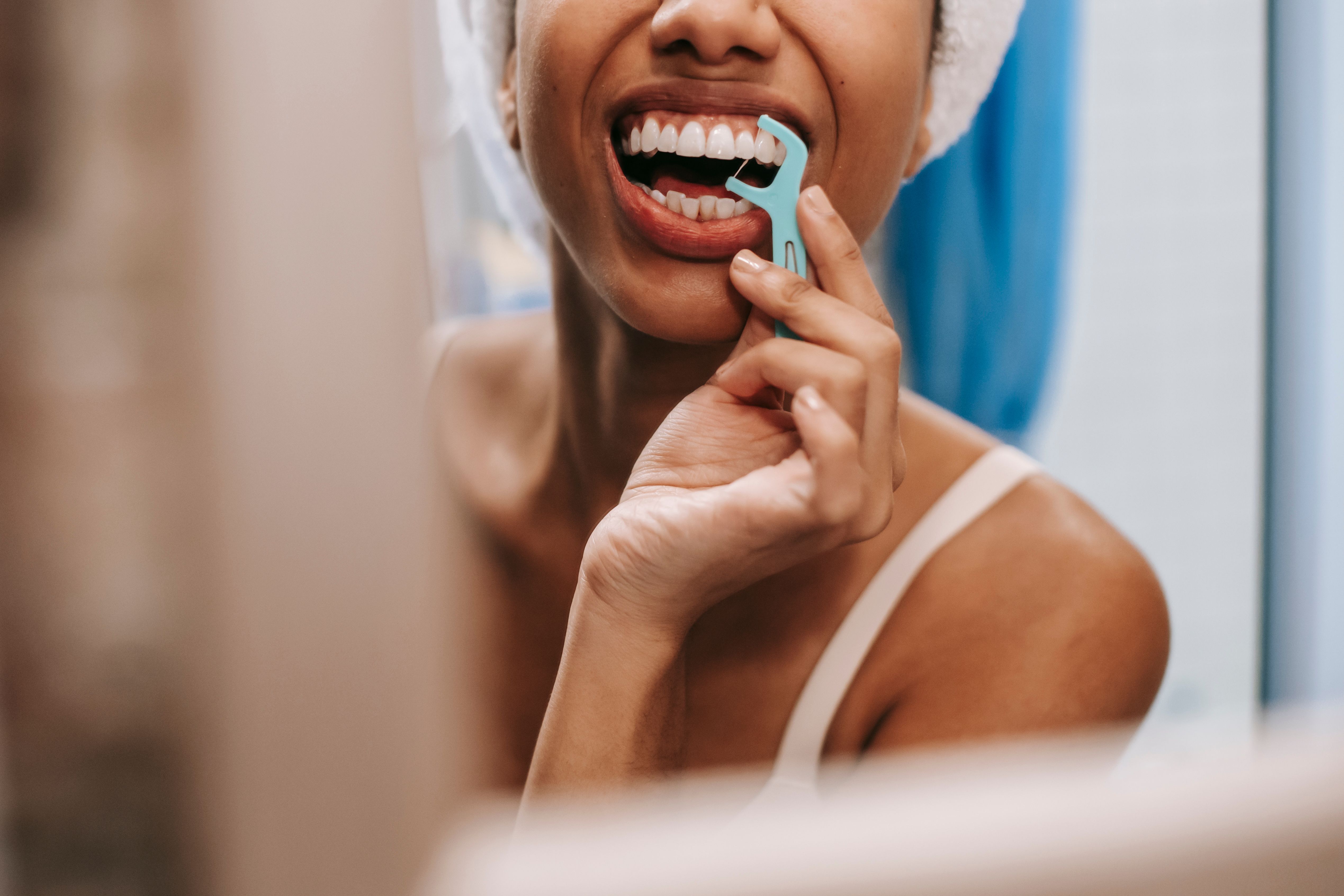 Why Does Floss Smell Bad Between Certain Teeth? 8 Possible Causes